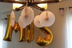 Create a fun selfie wall for guests with foil balloons, hanging paper lanterns, and a little bit of fun for everyone!