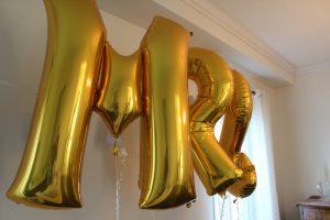 Create a fun selfie wall for guests with foil balloons, hanging paper lanterns, and a little bit of fun for everyone!