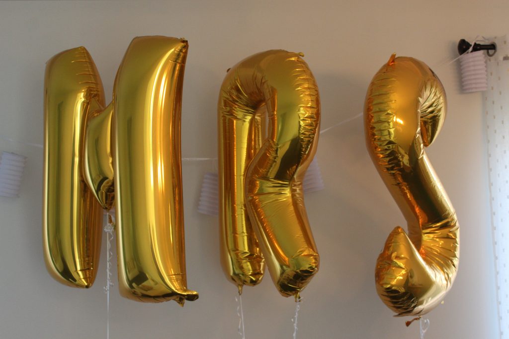 Create a fun selfie wall for guests with foil balloons, hanging paper lanterns, and a little bit of fun for everyone!